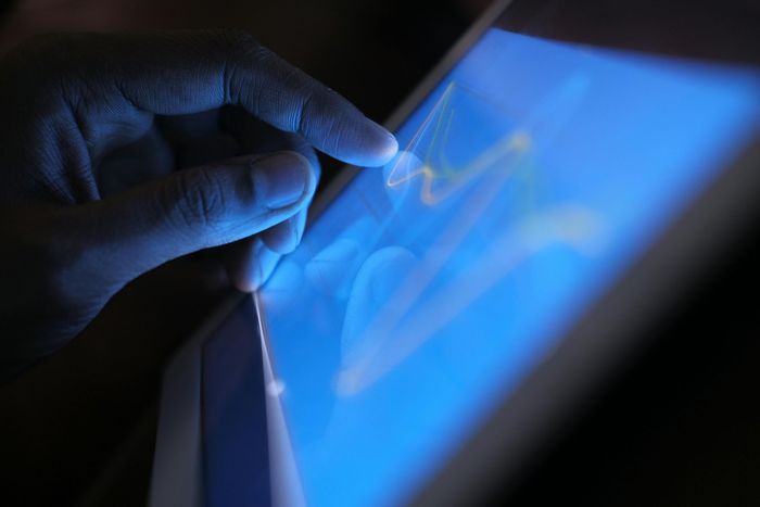 Business owner using a digital tablet to get a solar quote online.
