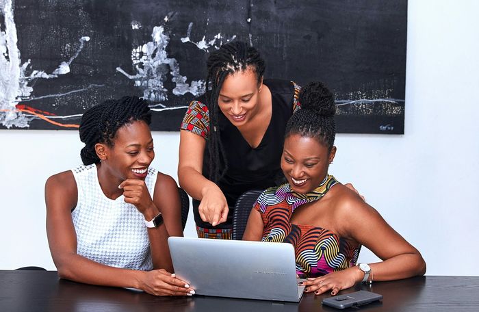 A team of women working together to strategize providing B2B energy services.