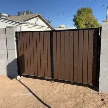 Wooden gate with concrete accents and modern masonry work