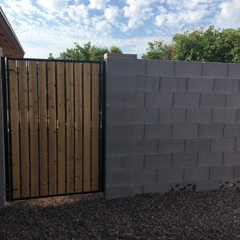Gate set into stucco-finished block wall built in Arizona