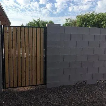 Gate set into stucco-finished block wall built in Arizona