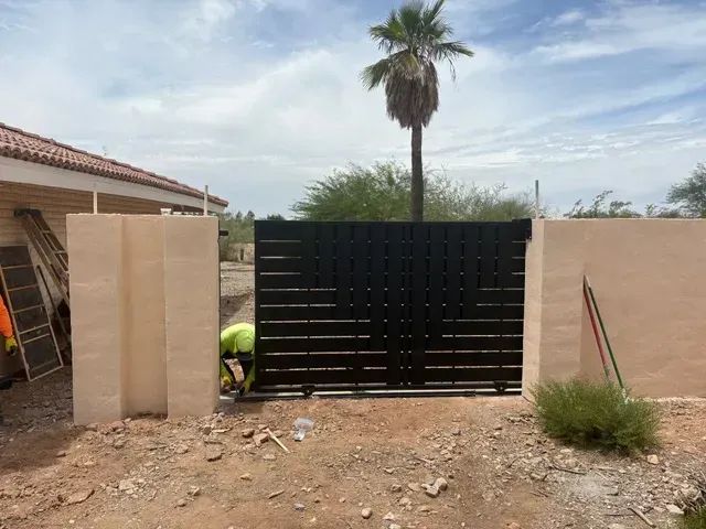 Gate installed with artificial grass and paver walkway AZ