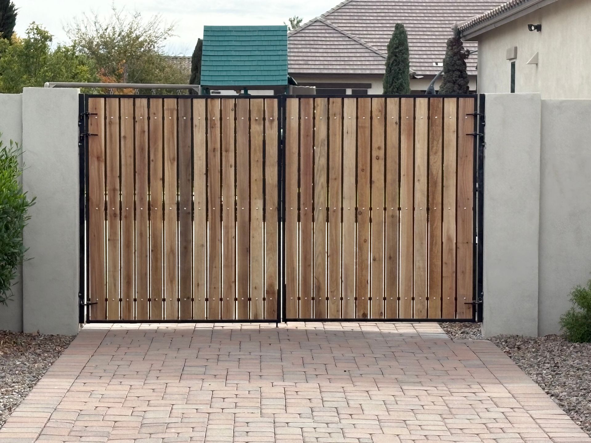 Driveway gate with brick and block pillars in Arizona