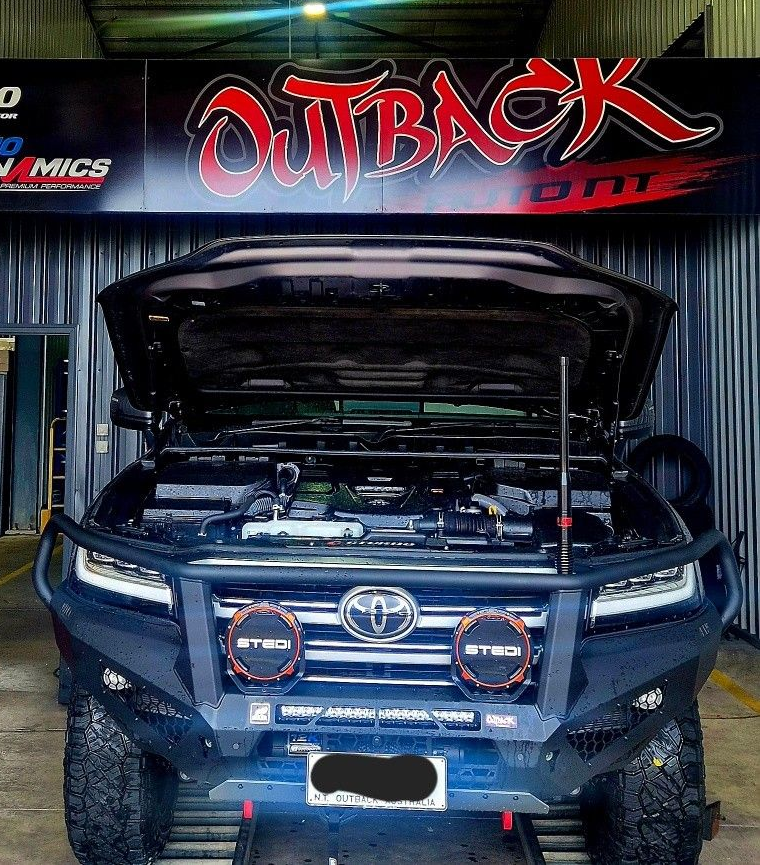 Blue Toyota SUV with hood open, displayed in an Outback garage with off-road lights and lifted suspension. — Outback Auto NT in Berrimah, NT