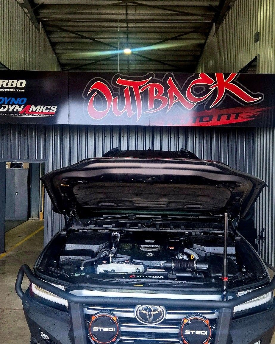 Black Toyota SUV with hood open inside an Outback 4x4 workshop garage. — Outback Auto NT in Berrimah, NT