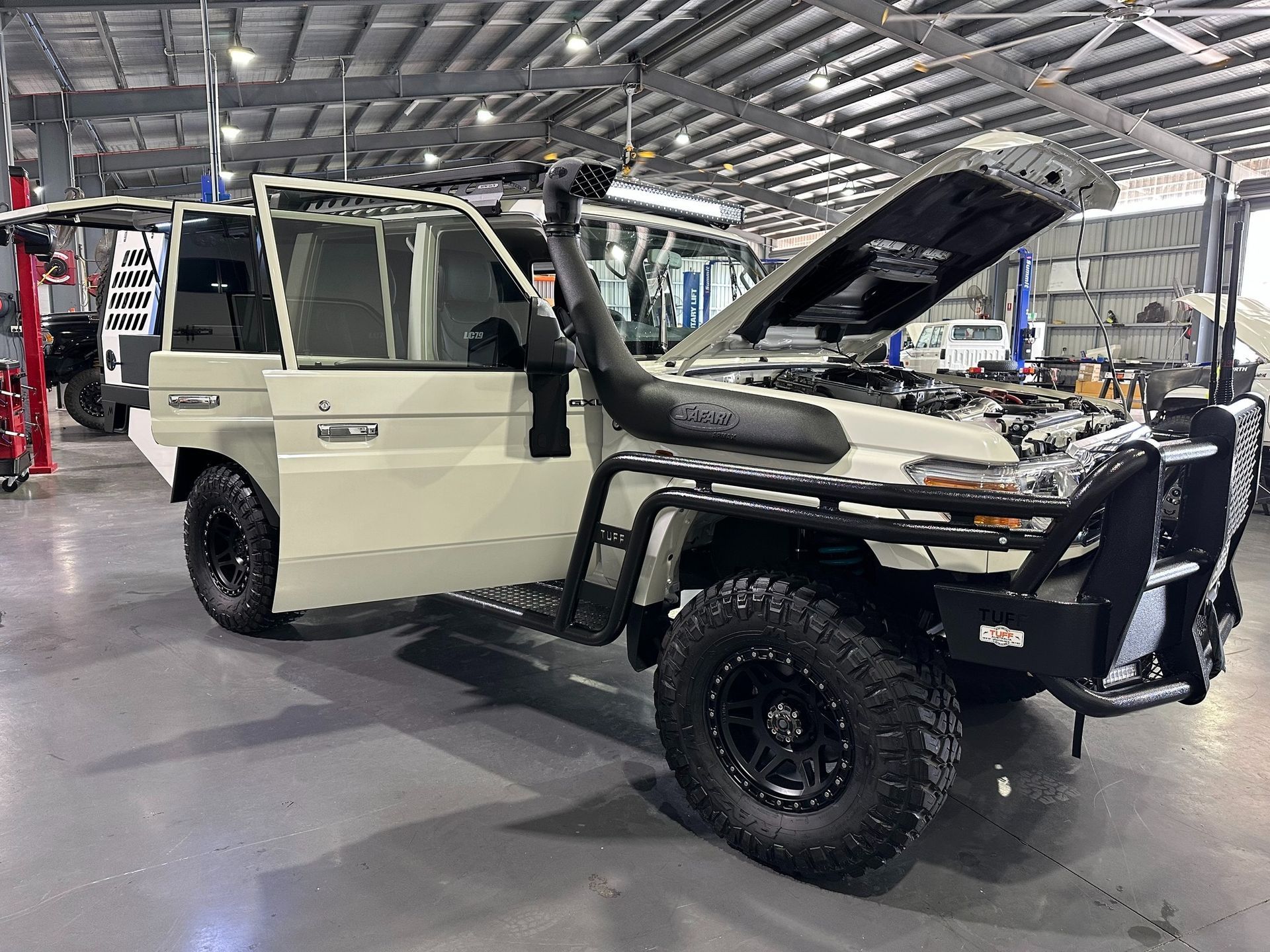 A Beige Off-road Vehicle With an Open Hood and Doors — Outback Auto NT in Berrimah, NT