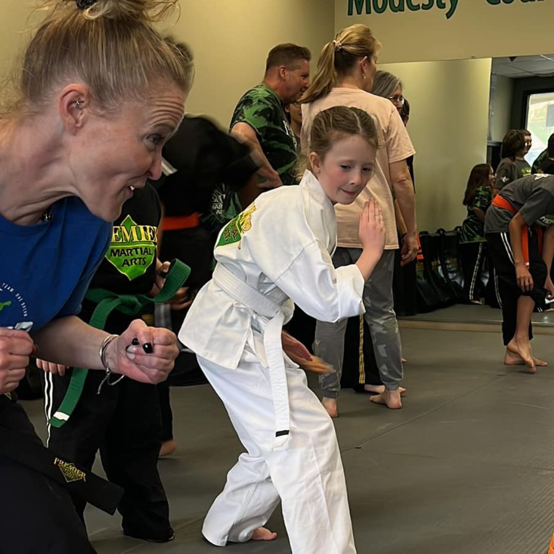 A boy and a girl are practicing taekwondo together.