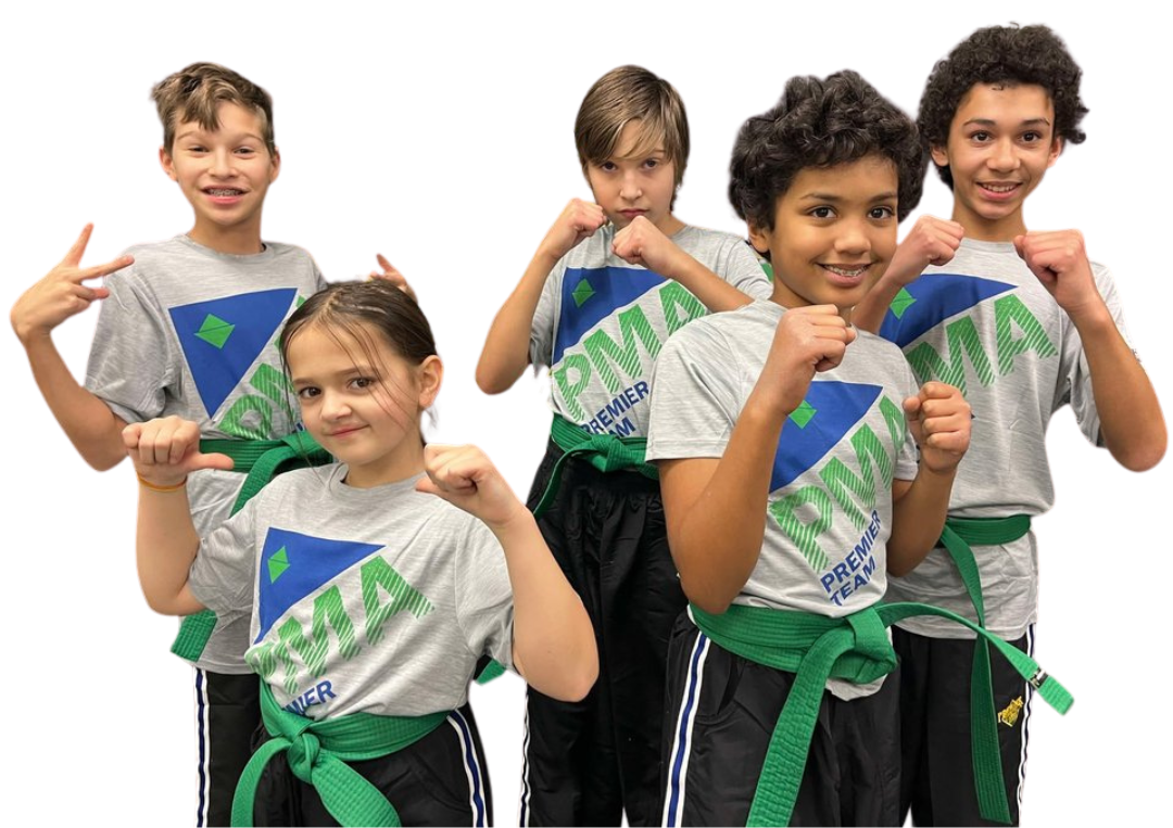 A group of kids in karate uniforms are sitting on the floor drinking water