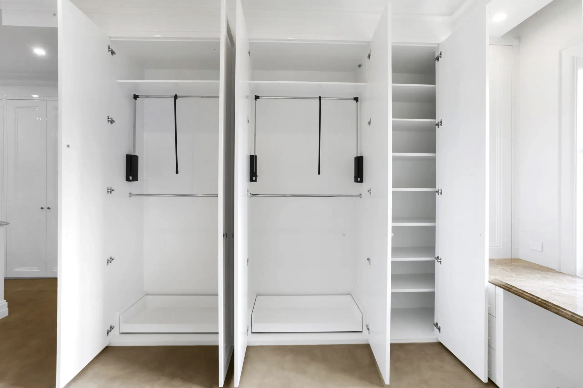 An empty closet with the doors open and shelves.