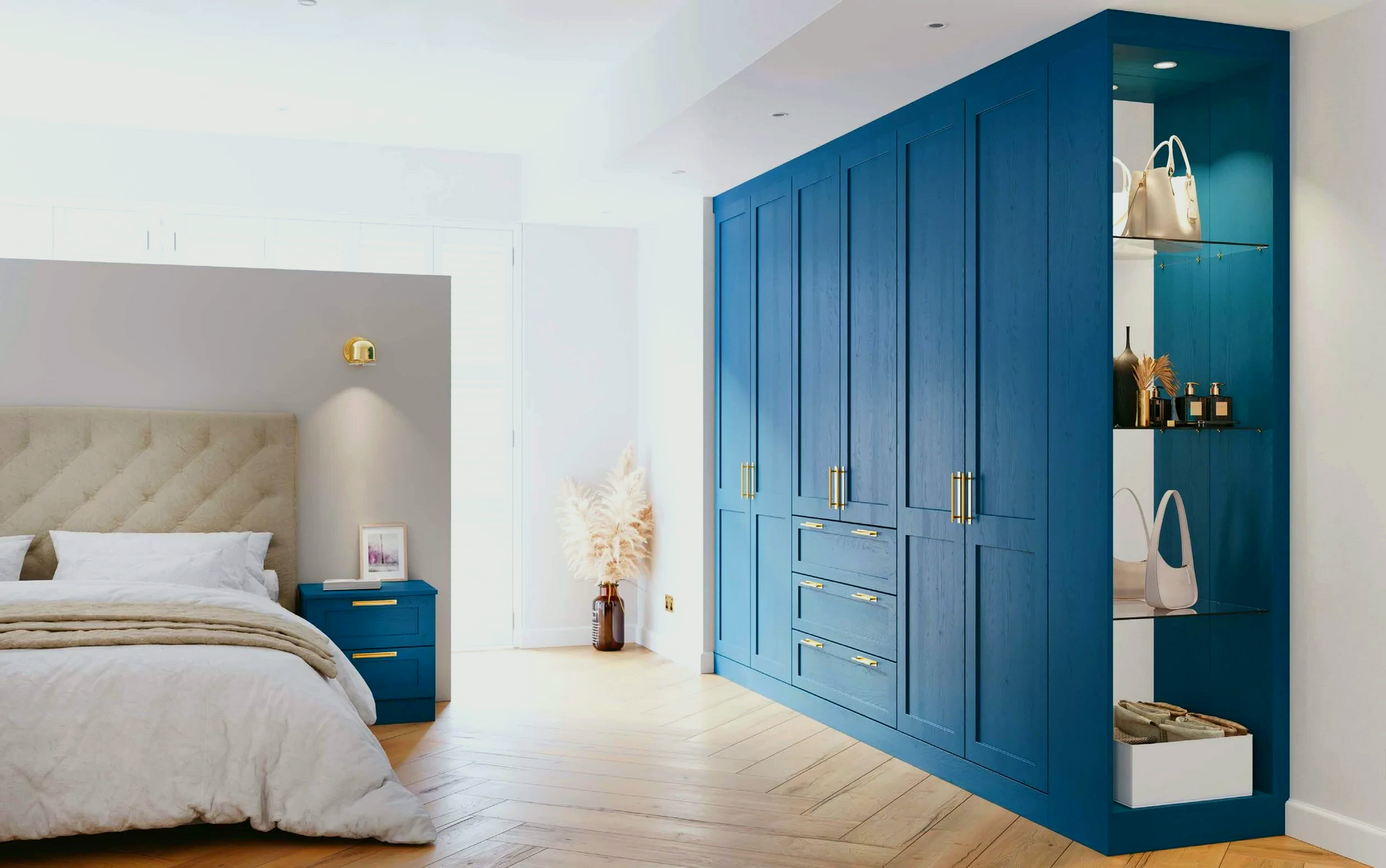 Blue built-in wardrobe with open shelving, next to a bed in a modern bedroom.