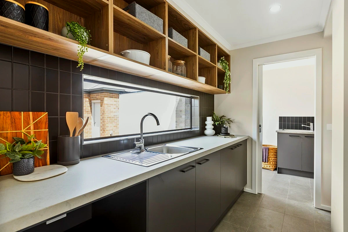 A kitchen with a sink and a large window.