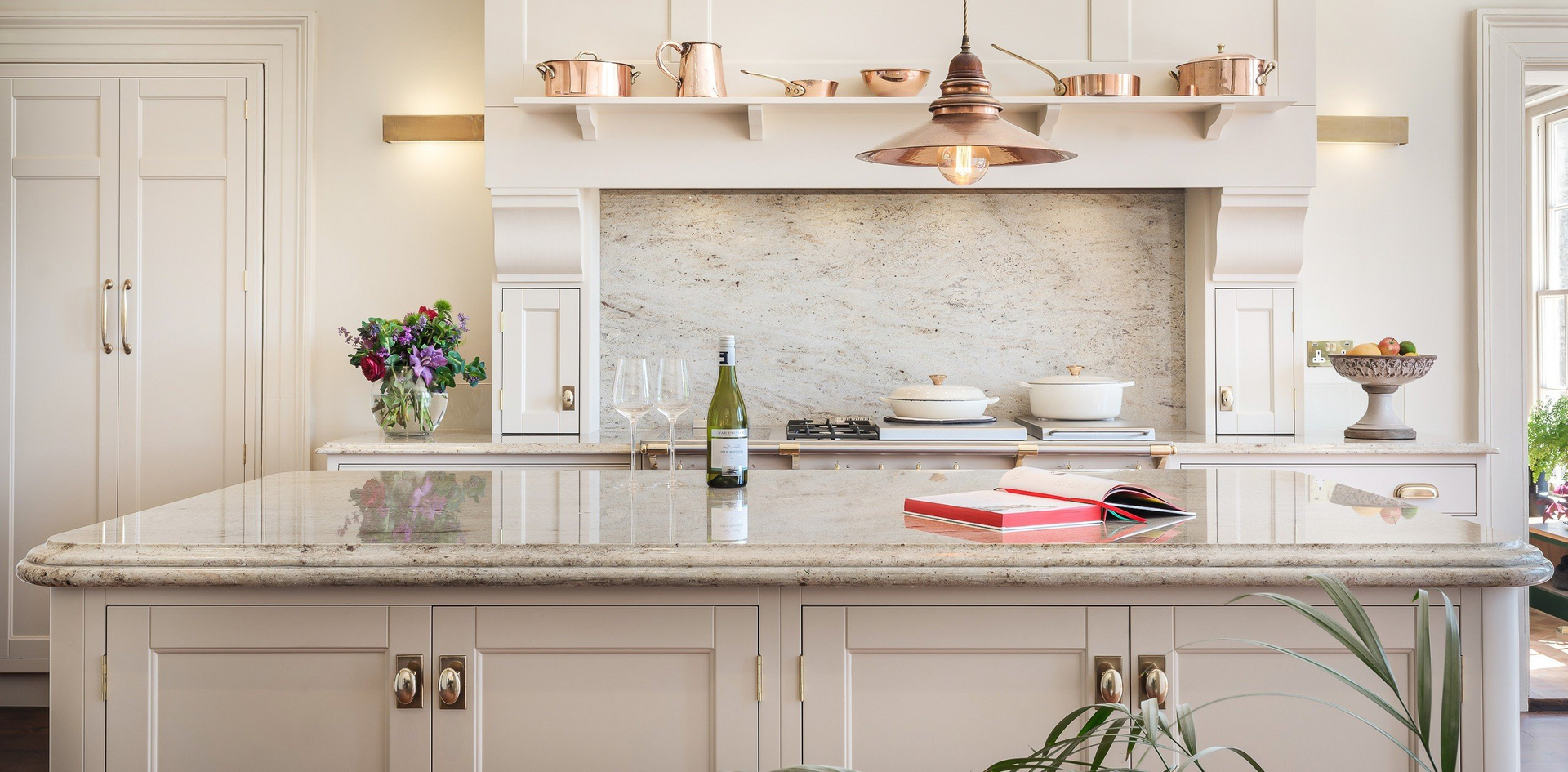 A classic kitchen with marble benchtop and light brown cabinets