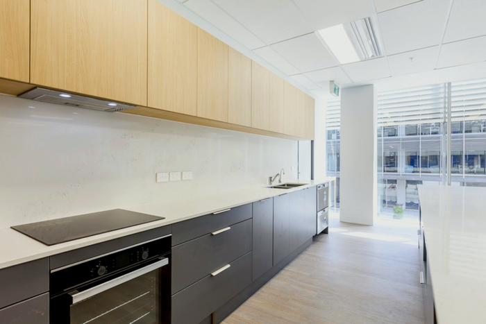 A kitchen with a stove top oven and a sink.