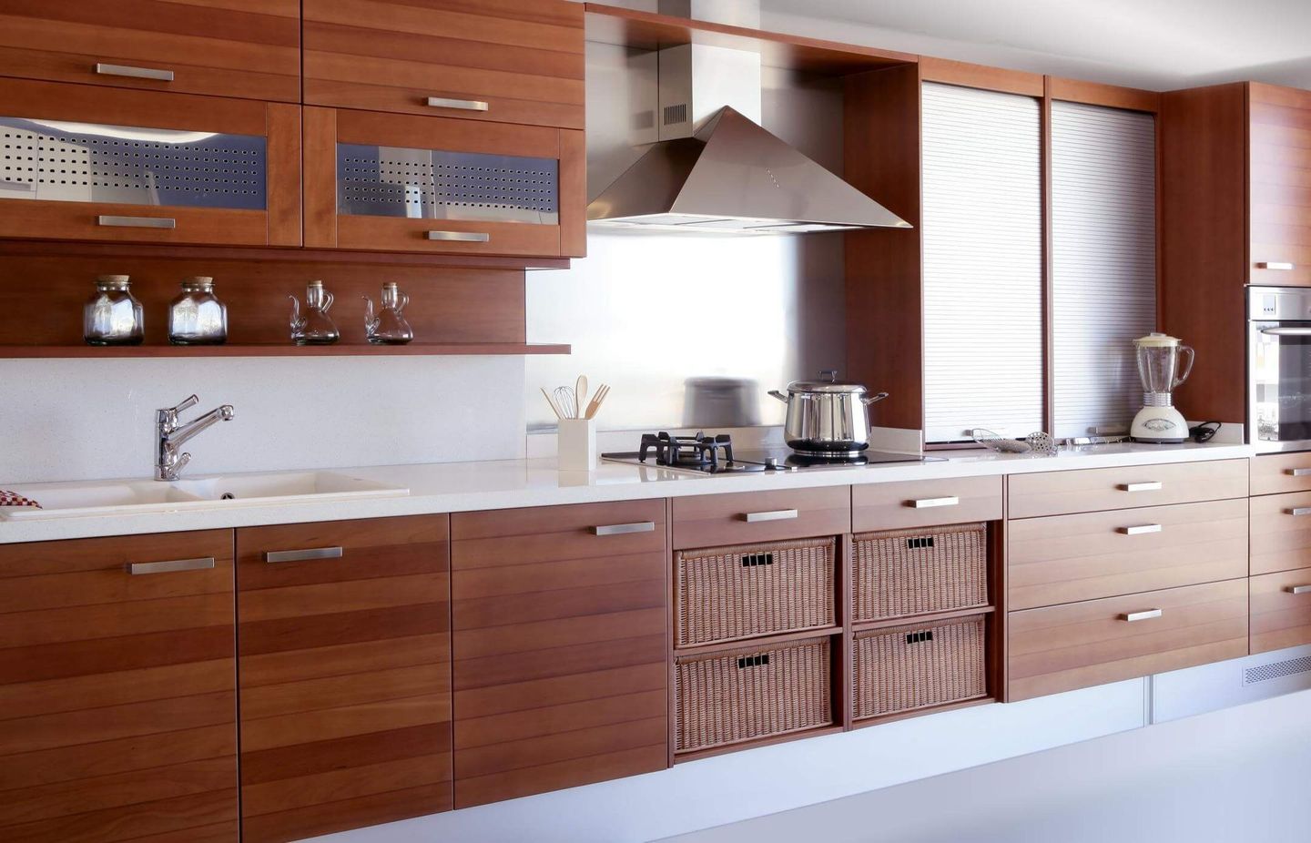 A kitchen with wooden cabinets and white counter tops