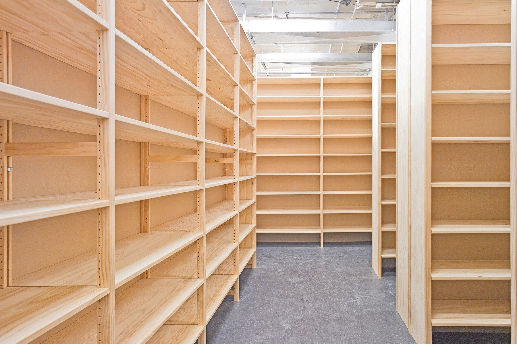 A room filled with lots of wooden shelves.
