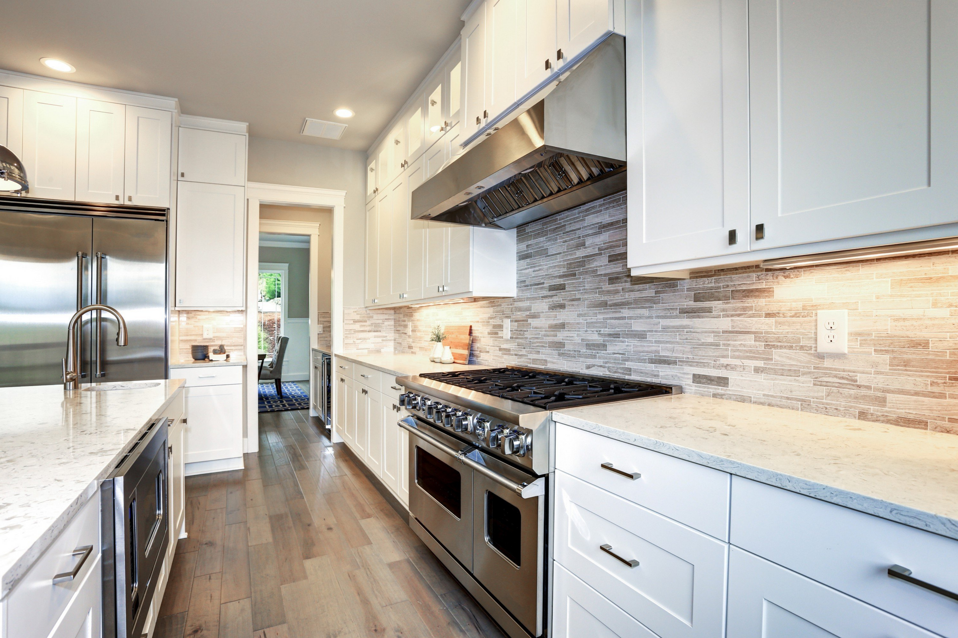 A kitchen with white cabinets and stainless steel appliances.