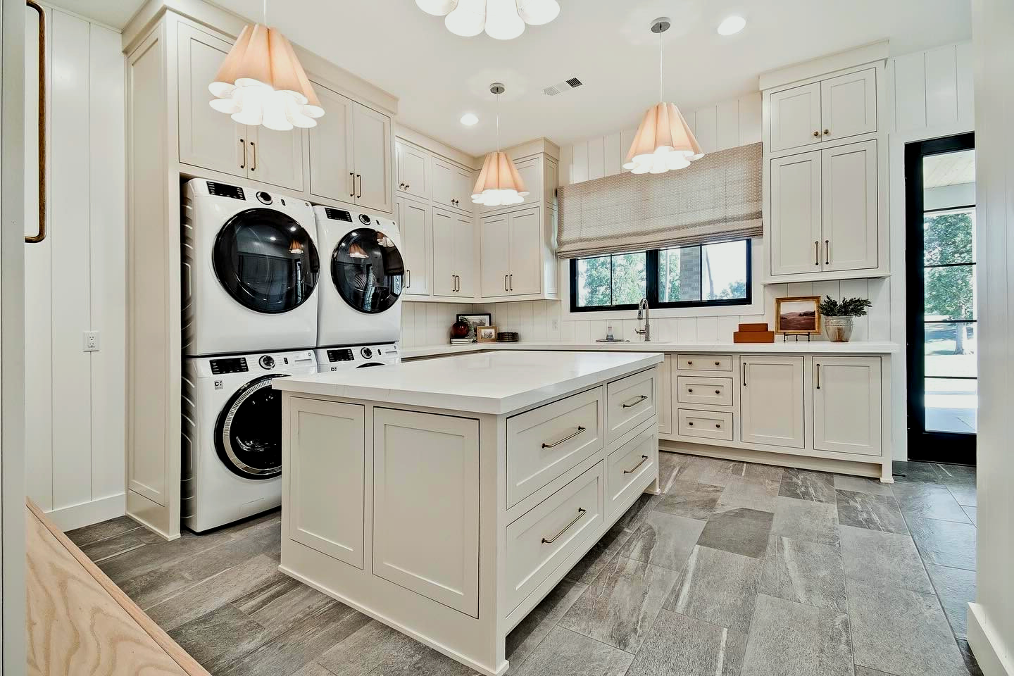 There is a large island in the middle of the laundry room.