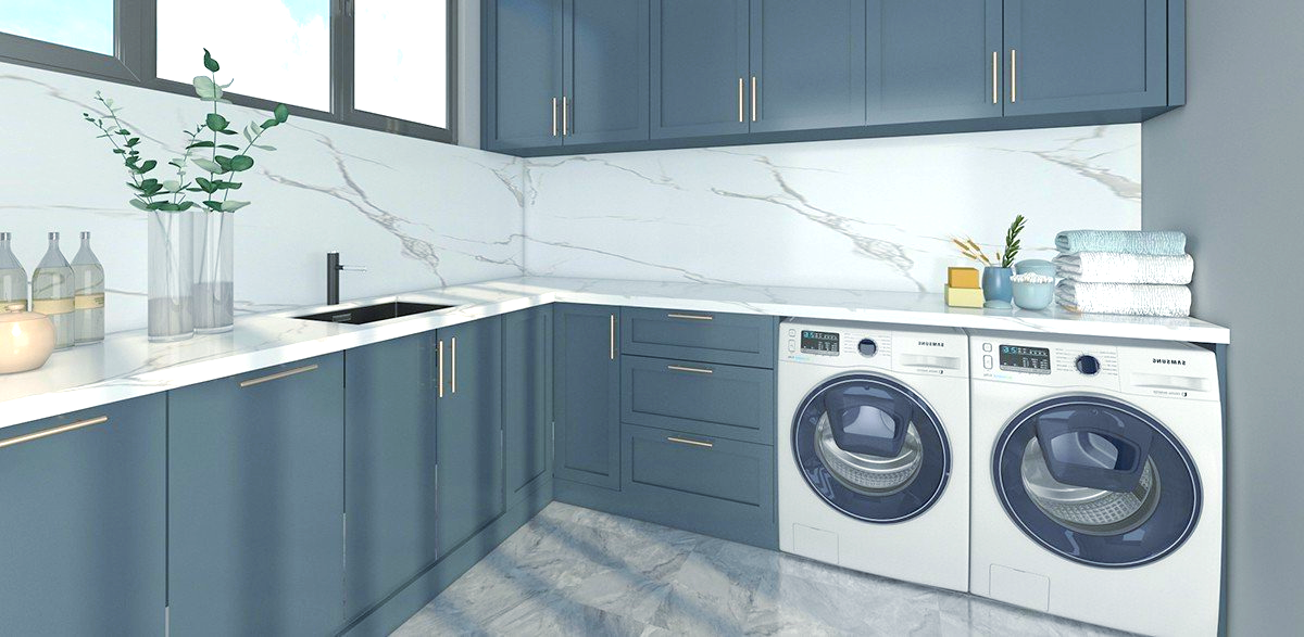 Laundry room with blue cabinets, white marble backsplash, and washing machine and dryer.