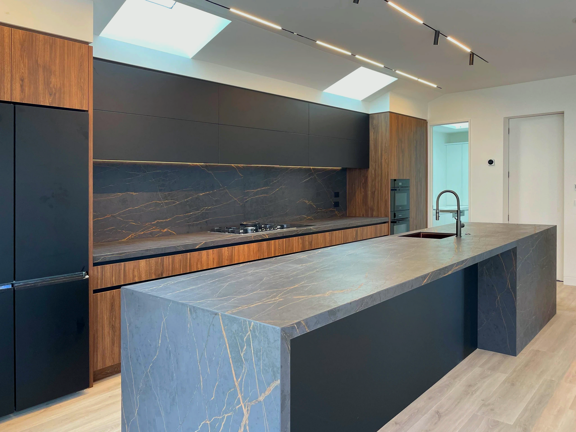 There is a large island in the middle of the kitchen.