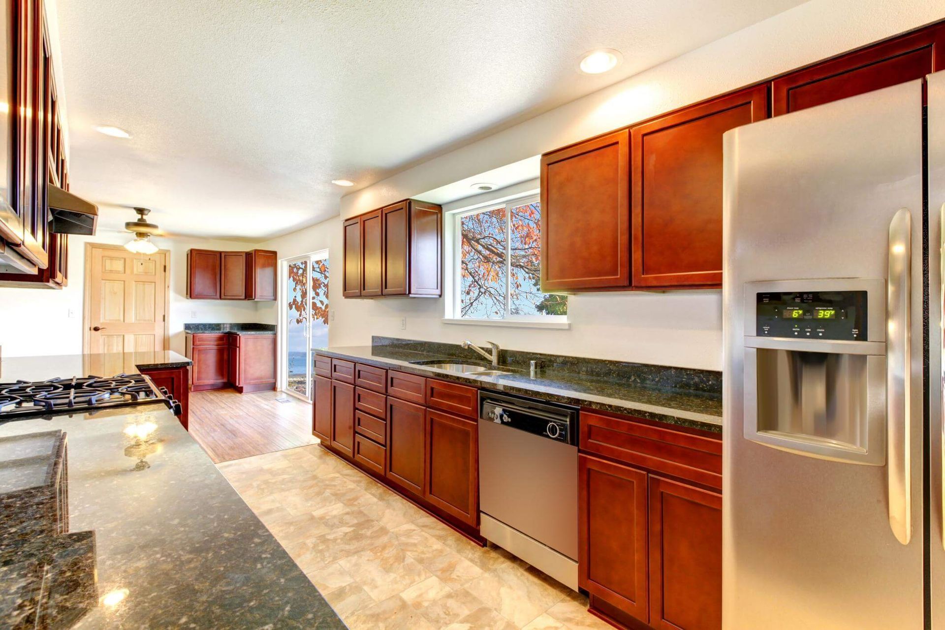 A kitchen with stainless steel appliances and wooden cabinets