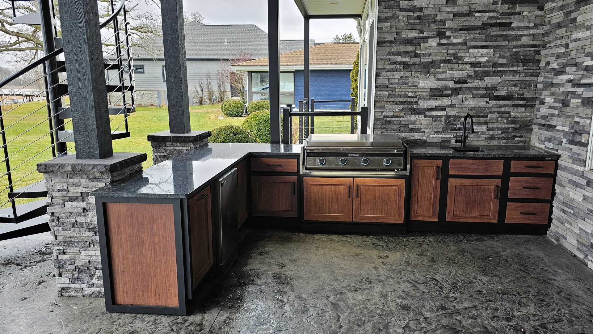 A kitchen with wooden cabinets and a granite counter top.