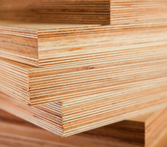 A close up of a pile of plywood stacked on top of each other.