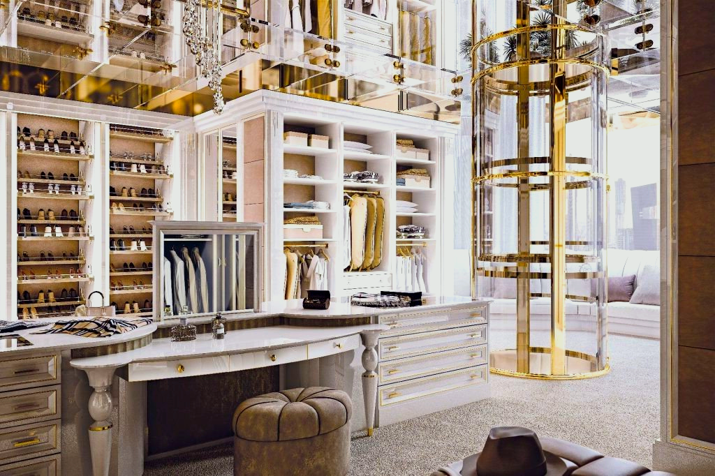 Luxurious gold and white walk-in closet with shelves, dressing table, and a circular garment rack.