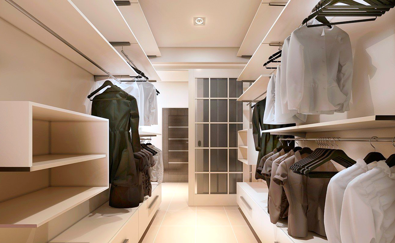 A walk in closet filled with clothes and shelves.