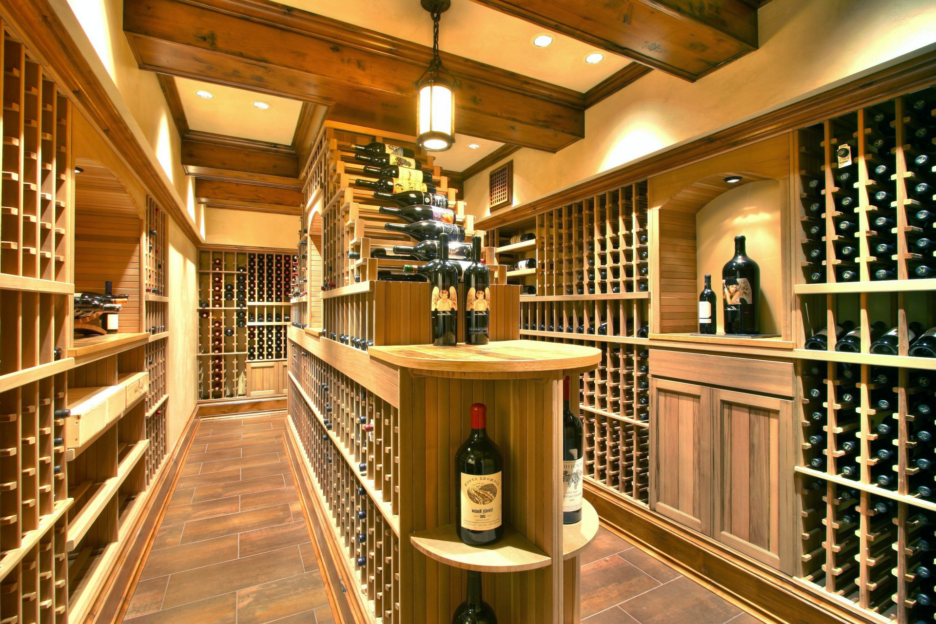 A bottle of wine is on a shelf in a wine cellar.