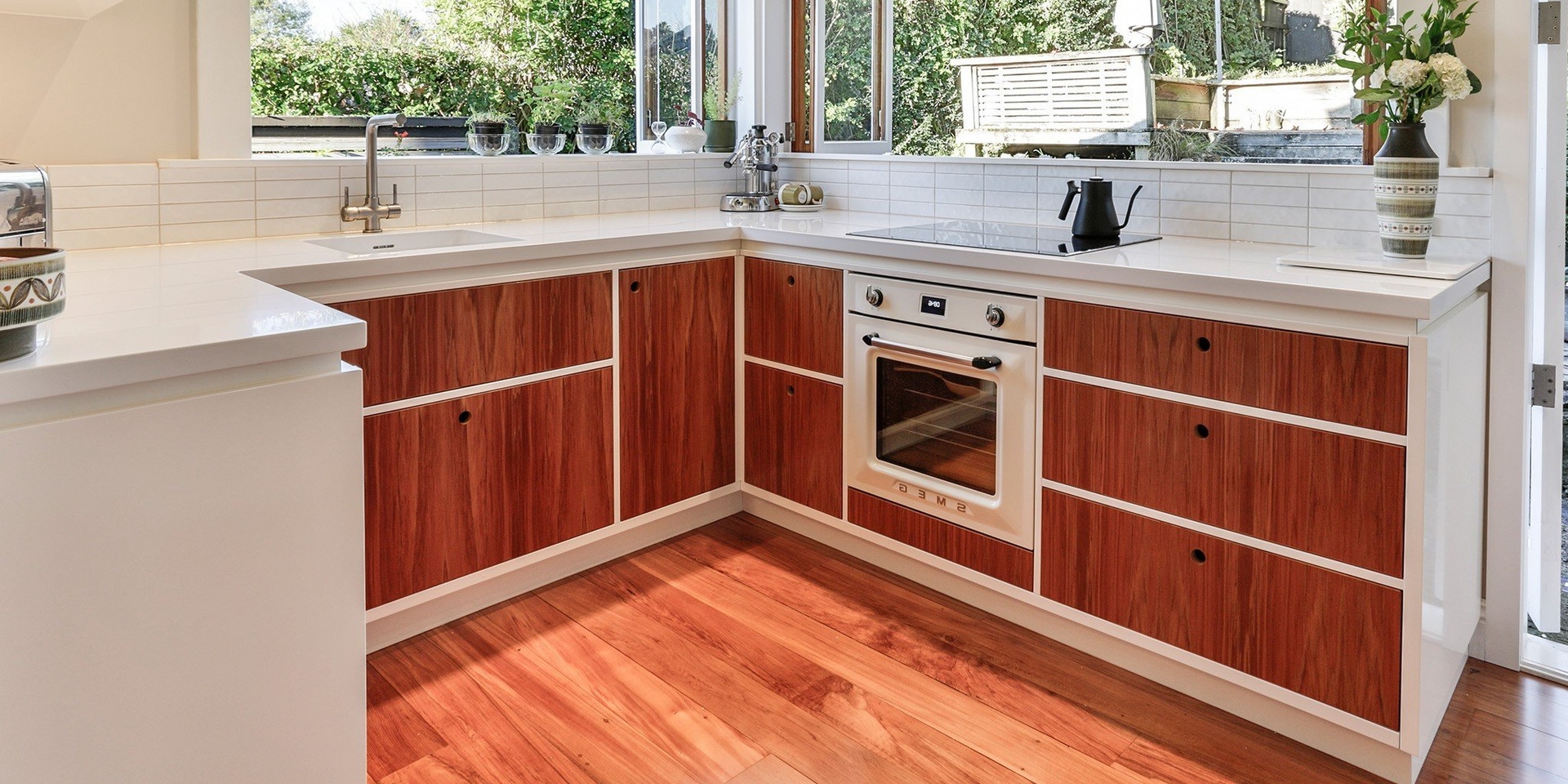 A kitchen with wooden cabinets and hardwood floors.