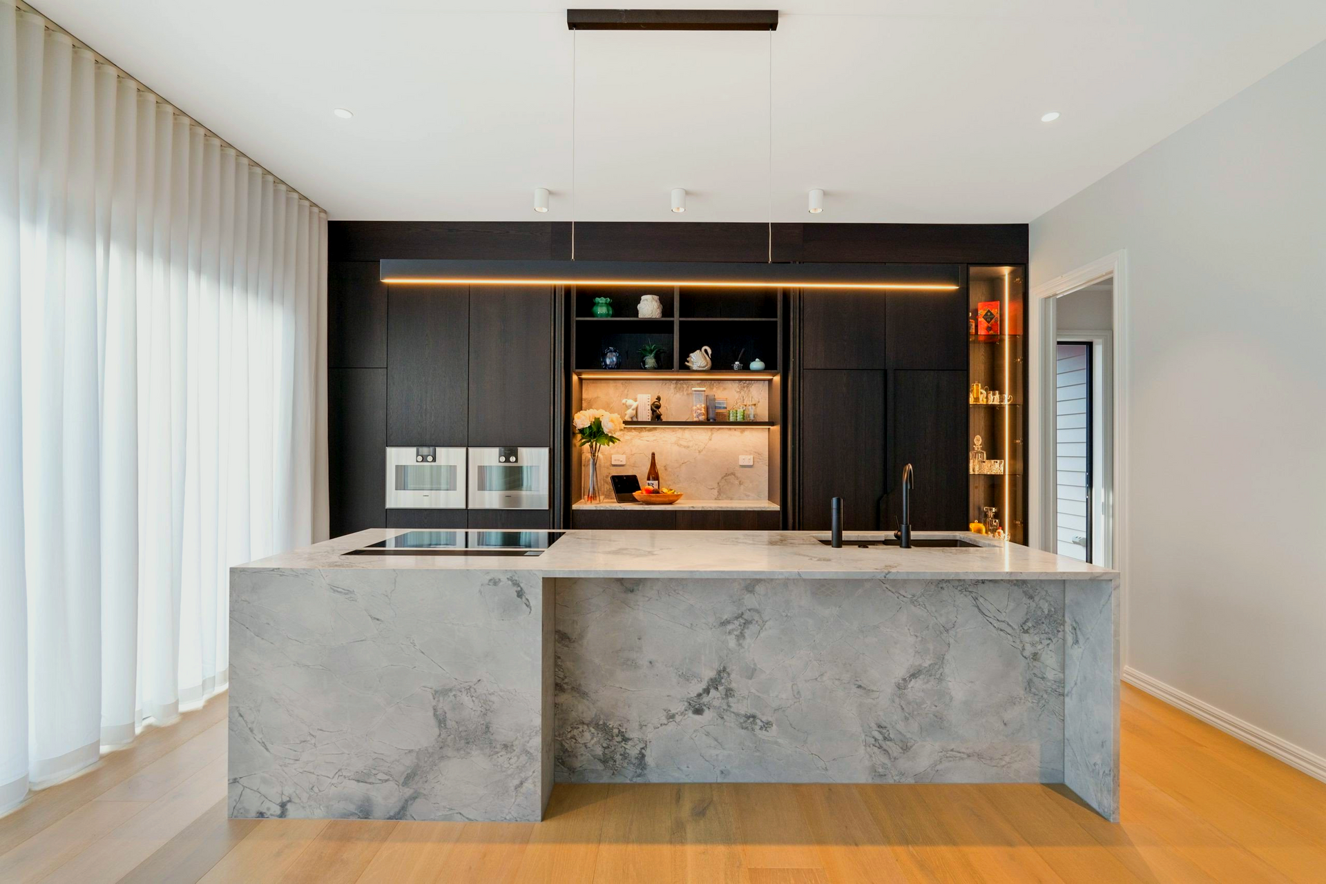 There is a large island in the middle of the kitchen.