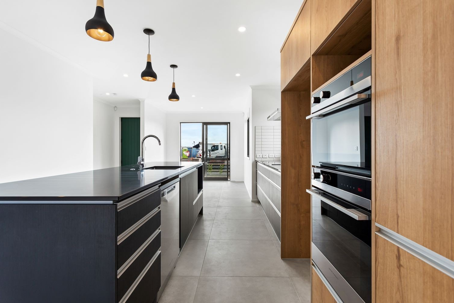 A kitchen with stainless steel appliances and wooden cabinets.