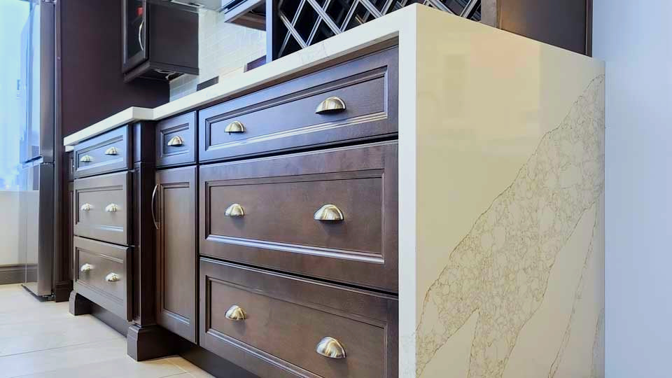 A kitchen with wooden cabinets and a granite counter top.