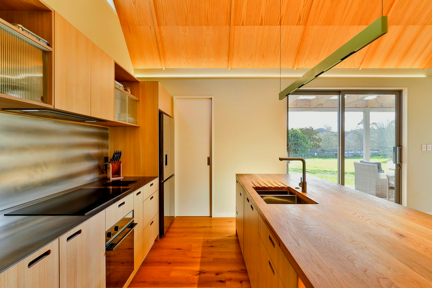 A kitchen with wooden cabinets and stainless steel appliances.