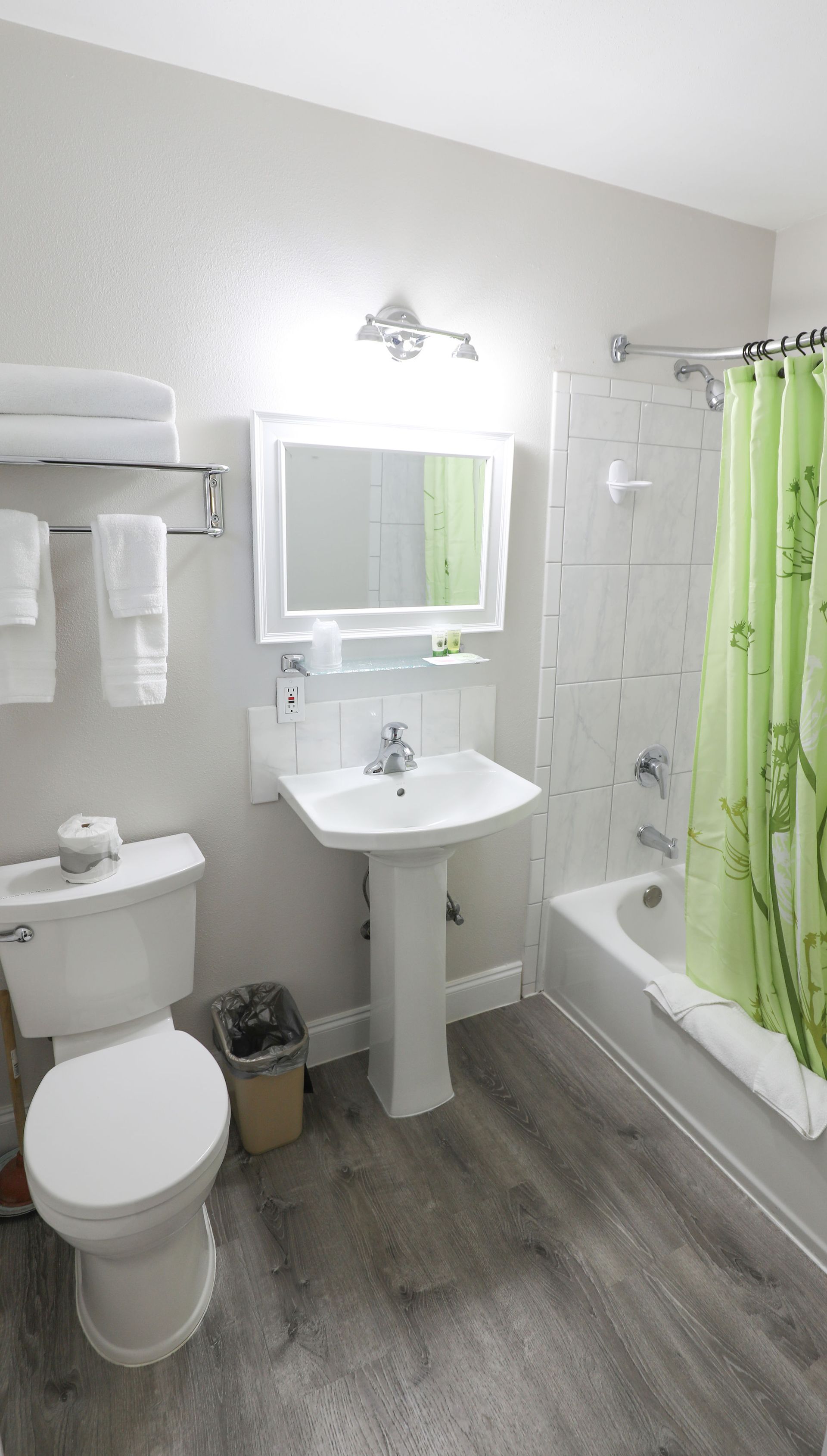 A bathroom with a toilet , sink , and bathtub.