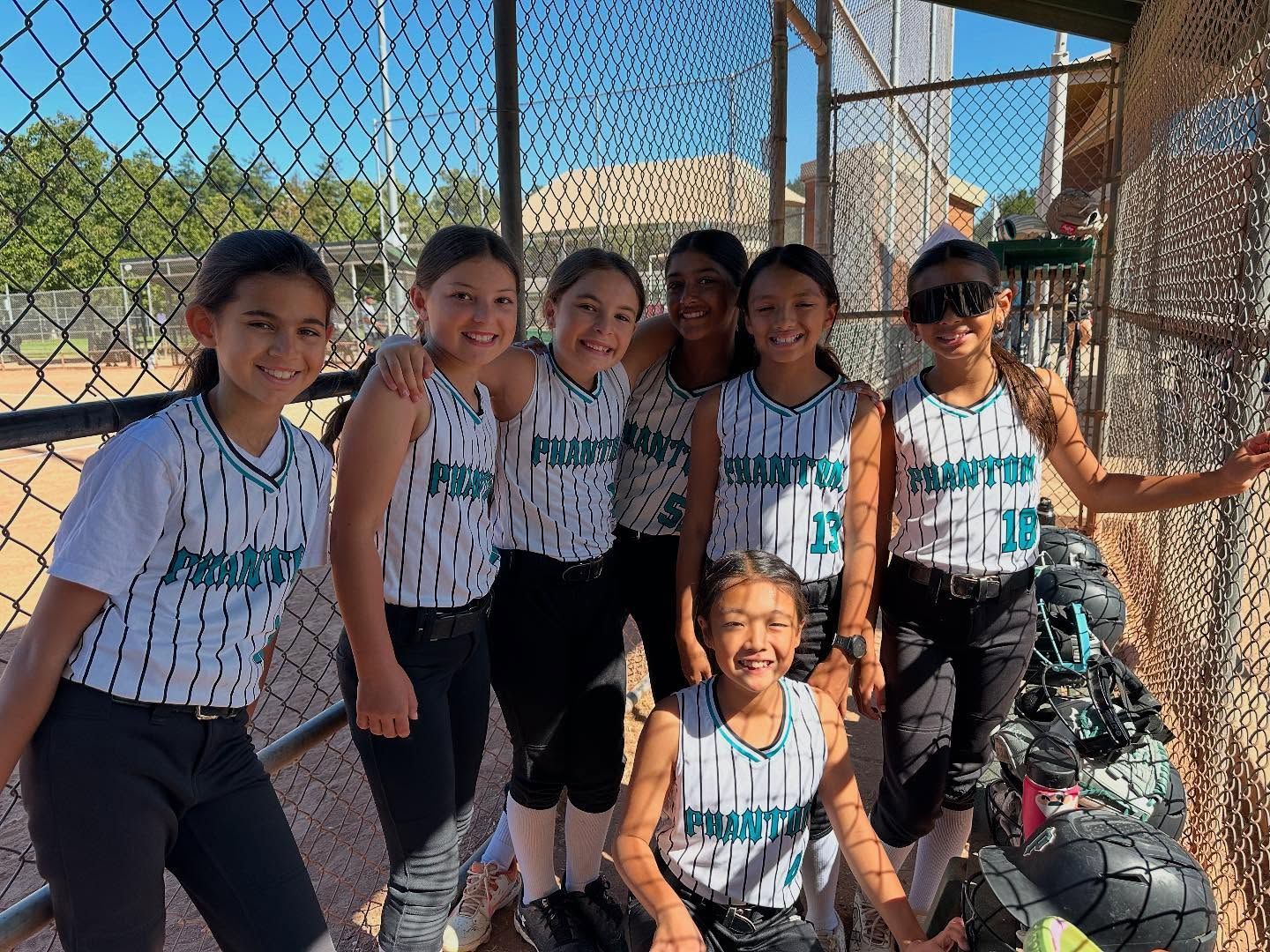Baseball player sliding into base as another player attempts to catch the ball.