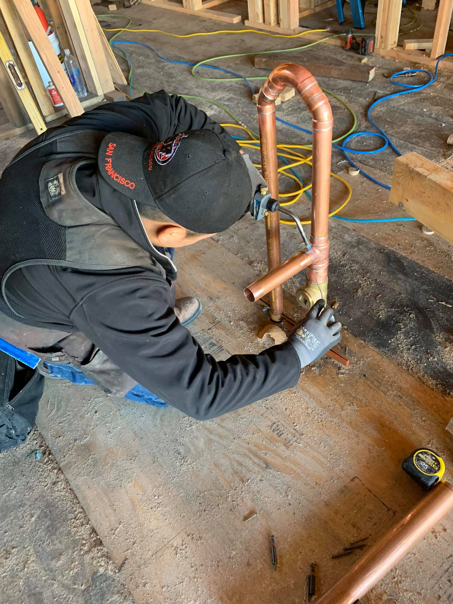 Man Installing Copper Plumbing Pipes — San Francisco, CA — Bayworks Plumbing