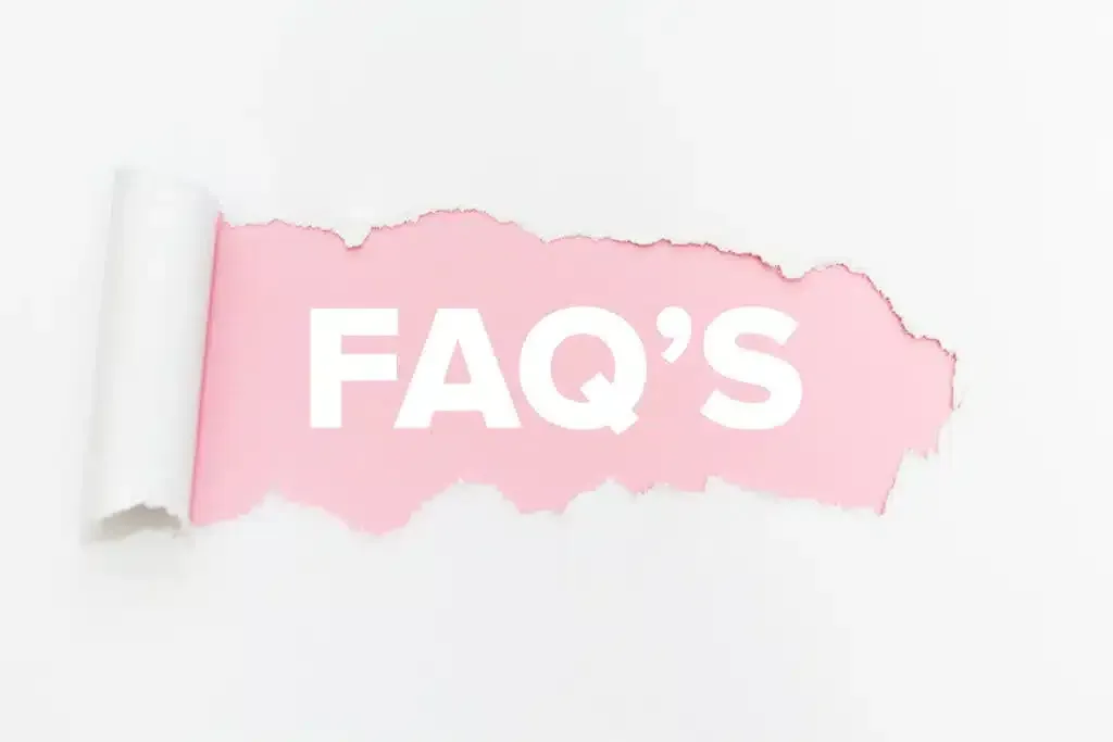 White paper torn to reveal pink background with 