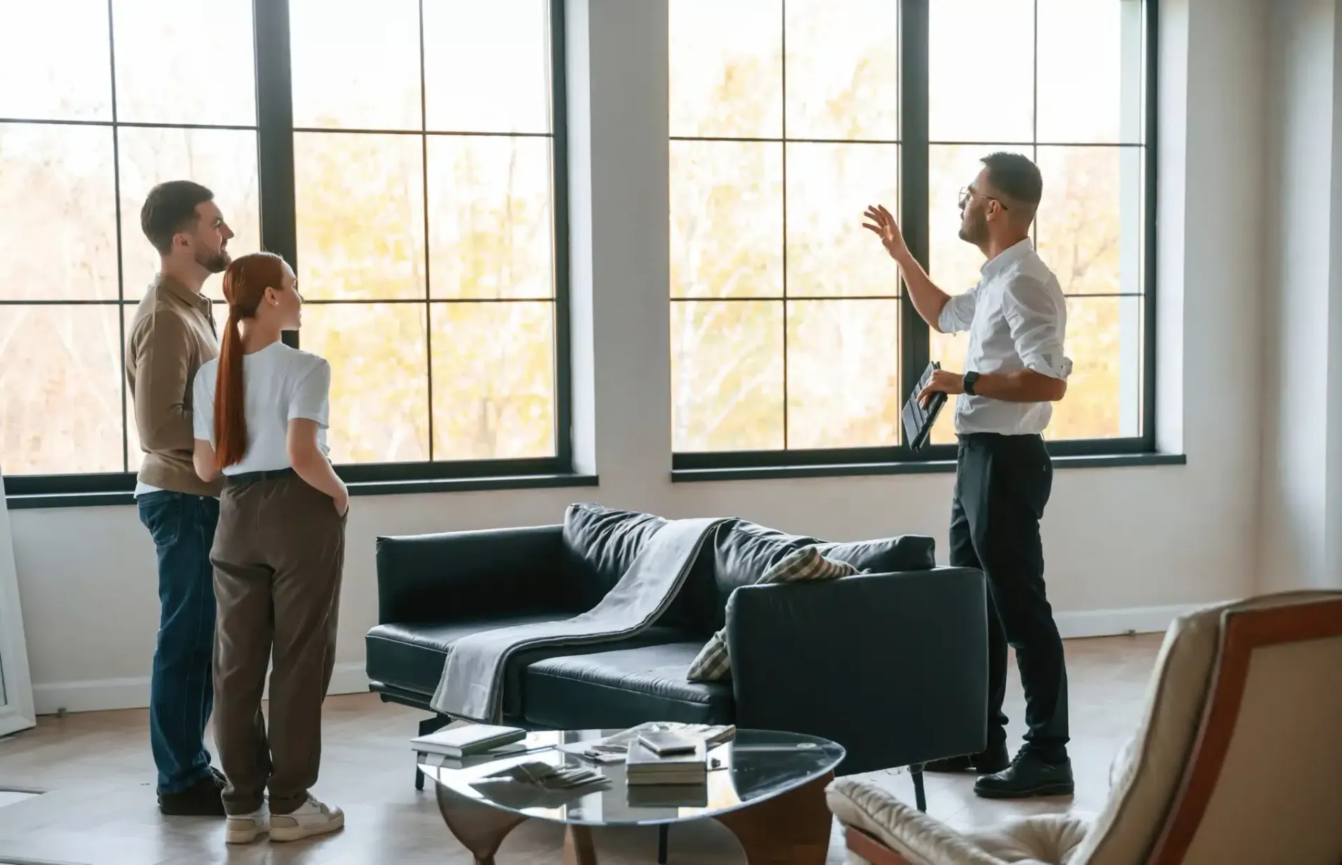 Real estate agent showing a couple a room in an apartment.