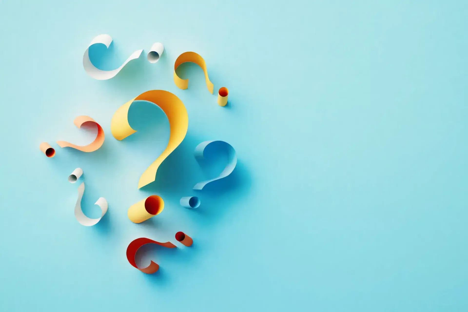Colorful paper question marks on a light blue background.