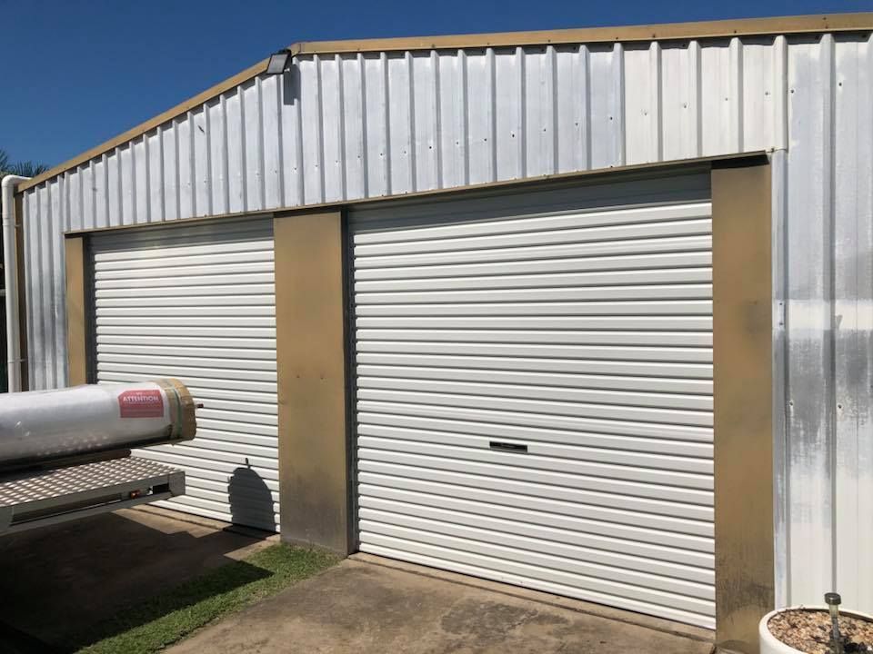 A White Garage Door With a Gold Trim on the Side of It — Mackay Garage Doors in Andergrove, QLD
