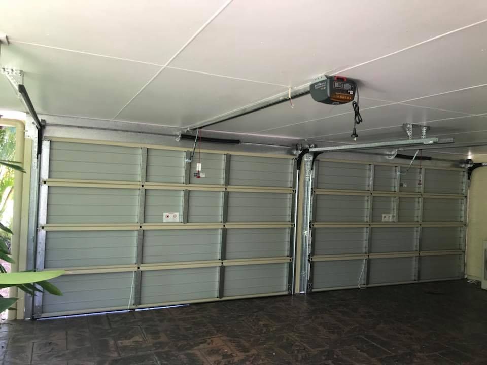 A Garage With a Garage Door Open and a Garage Door Opener — Mackay Garage Doors in Andergrove, QLD