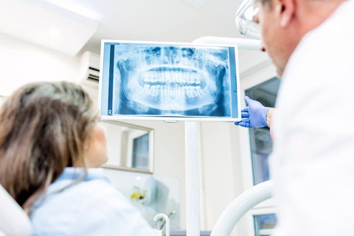 Examining Dental X-ray — Spokane, WA — Dr. Michael Readel, D.D.S.