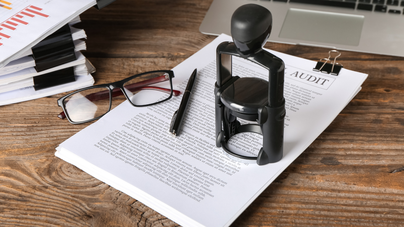 A stamp is sitting on top of a piece of paper on a wooden table.