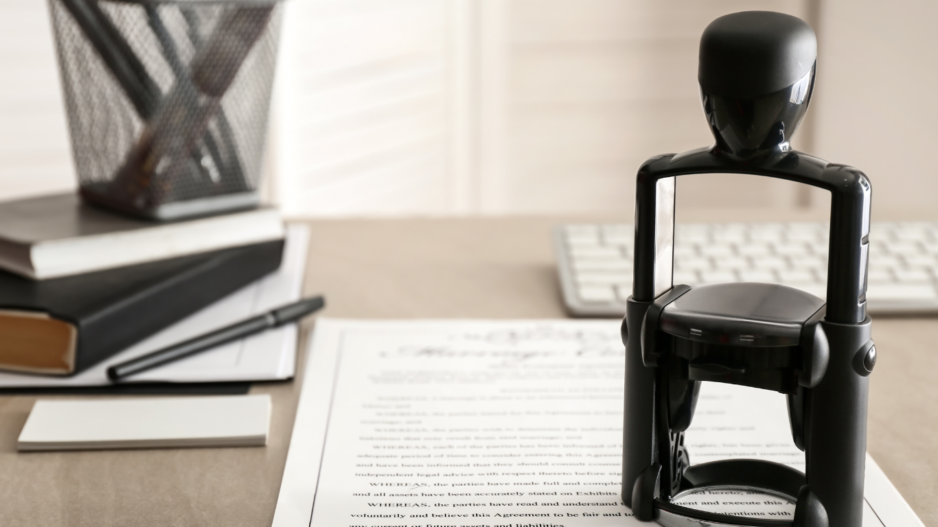 A stamp is sitting on top of a piece of paper on a desk.