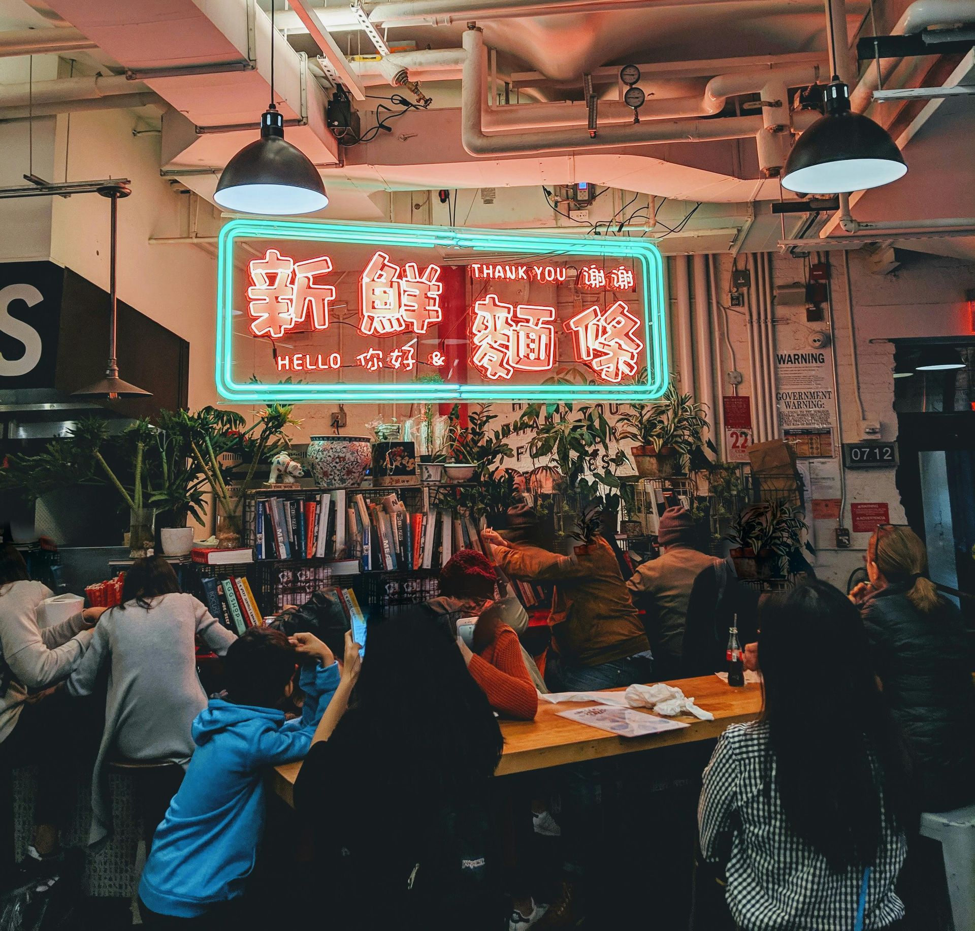 Business meeting in a modern conference room with city view, white board, and food on the table.