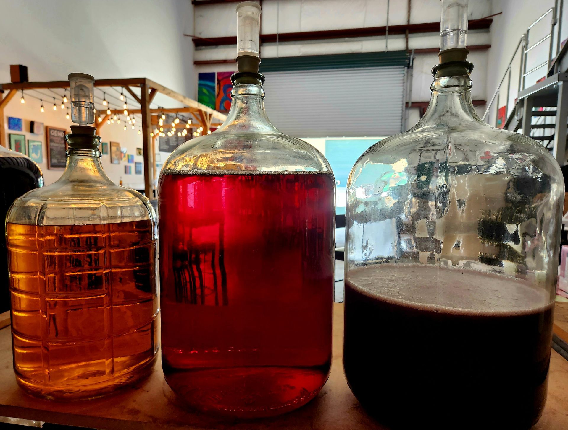 Three Big Bottles Of Wine On The Wooden Table | Kailua, HI | Oeno Winemaking