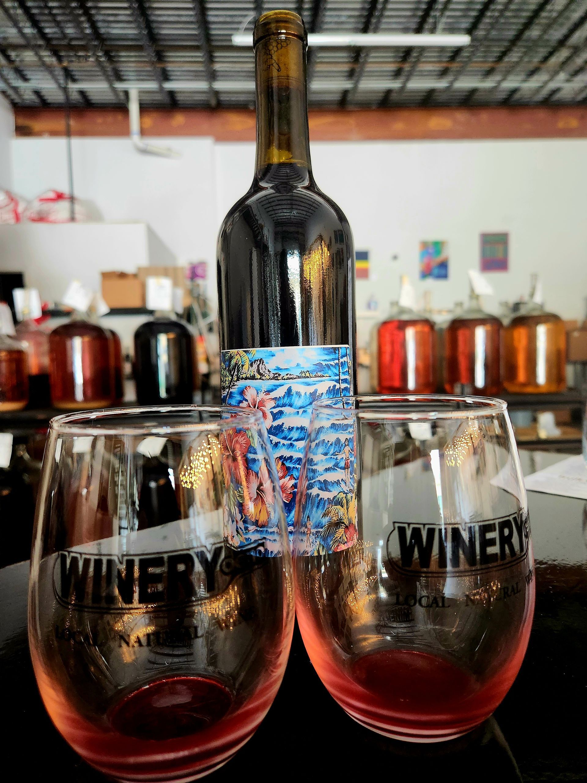 A Bottle Of Wine Sits Next To Two Wine Glasses | Kailua, HI | Oeno Winemaking