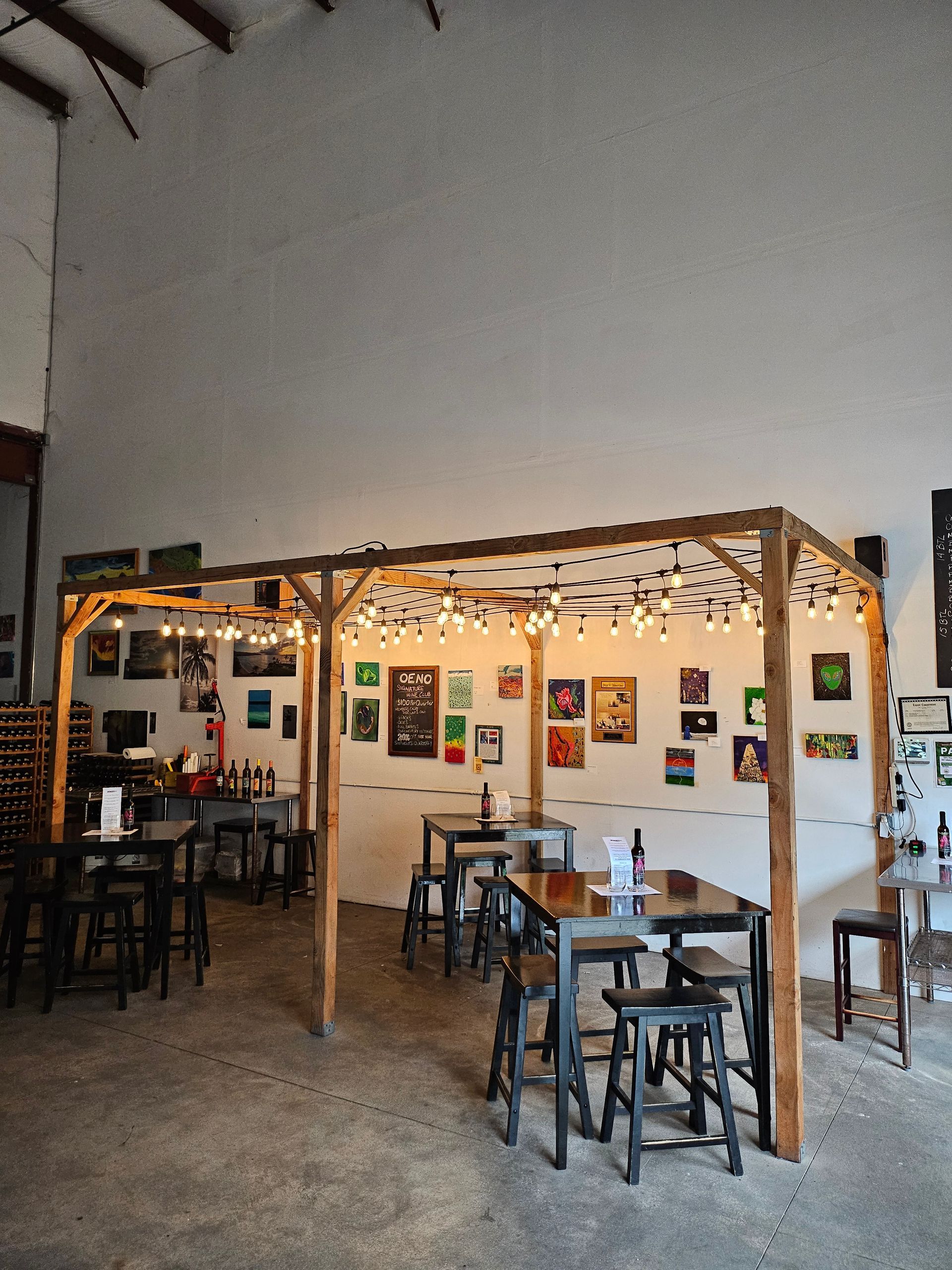 A Restaurant With Tables Under A Canopy | Kailua, HI | Oeno Winemaking