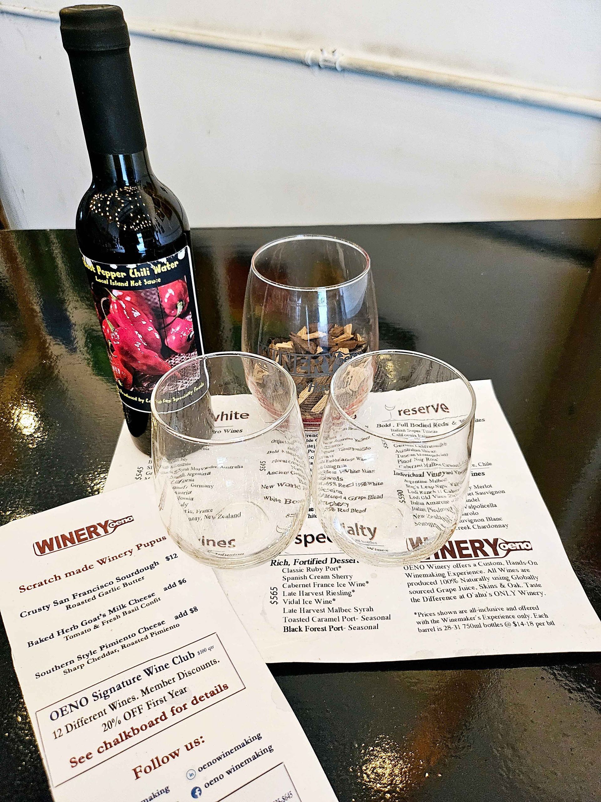 Bottle of Wine Sits on a Table | Kailua, HI | Oeno Winemaking